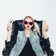 © Kaponia Aliaksei - woman in sunglasses  showing victory by finger