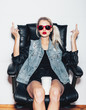© Kaponia Aliaksei - blonde woman in sunglasses showing middle finger
