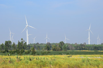 wind turbine against cloudy blue sky background