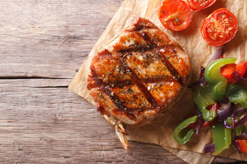 pork steak with vegetables close-up  horizontal top view, rustic