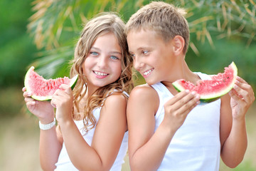 Portrait of a boy and girl on the beach in summer