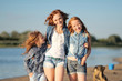 © zagorodnaya - mother and her two daughters on the beach in summer