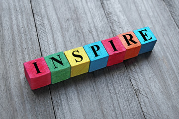 word inspire on colorful wooden cubes