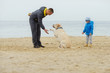 © Elena Stepanova - family with dog on the beach