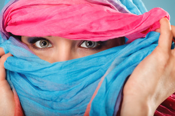 Wall Mural - woman makeup on eyes hiden her face with shawl