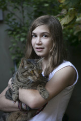 Wall Mural - smiling teen girl with the cat in the garden