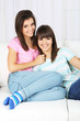 © Africa Studio - Beautiful girls twins sitting on sofa in room