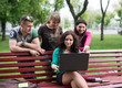 © lexmomot - Group of young college students using laptop