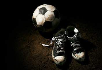 Wall Mural - Soccer ball on ground on dark background