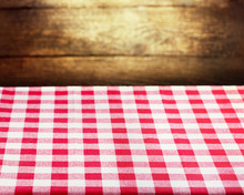 Checkered Red Tablecloth Over Wooden Background