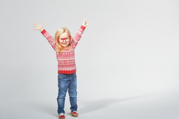 Blond girl in red glasses and a sweater