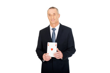 Elegant business man with red ace card