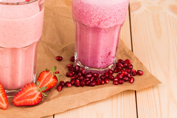 Wall Mural - Strawberry milkshake on a wooden background.