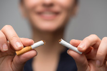 Addiction. Closeup Of Young Attractive Woman Breaking Cigarettes