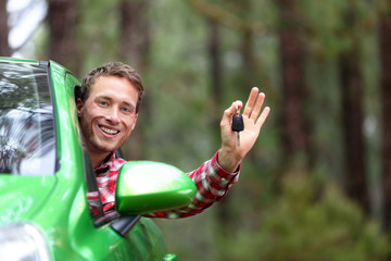 Car driver showing car keys happy