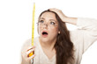 young woman is stunned by the size shown on the measuring tape