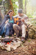 © jackfrog - a couple sitting near a campfire, he plays guitar
