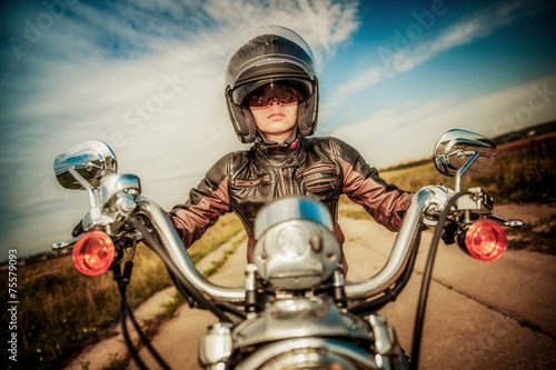 Nowoczesny obraz na płótnie Biker girl on a motorcycle