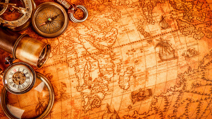 vintage magnifying glass lies on an ancient world map