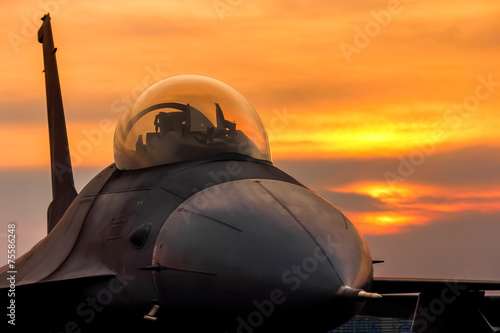 Fotografía Avión de combate F-16 Falcon en el fondo la puesta del sol