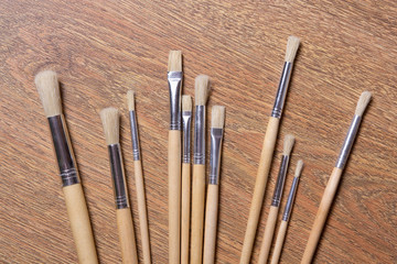 close up of paint brushes set on the table