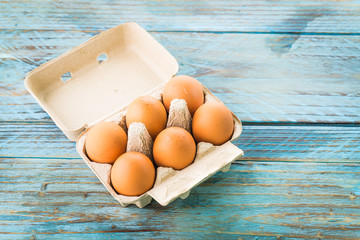 Canvas Print - eggs pack on wood background