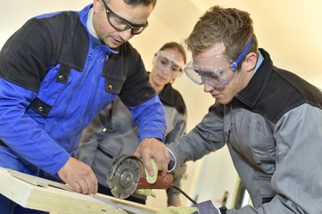 Wall Mural - Students learning how to use ceramic saw