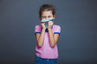 © maxximmm - girl child sneezes into  handkerchief on a gray background
