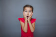 © maxximmm - girl on gray background opened her mouth in surprise