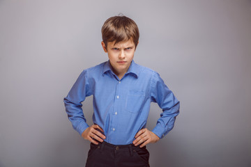 Wall Mural - angry teenager boy on  gray background