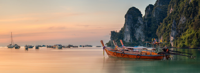 sunset with colorful sky and boat on the beach