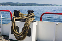 Boat With Mooring Rope Around A Bollard.