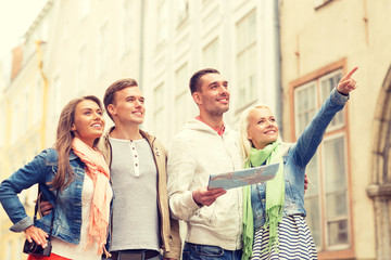 Poster - group of smiling friends with map and photocamera