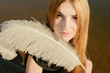 © sinada - unusual gothic girl with long red hair and feather