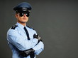 Portrait of policeman in sunglasses gray background