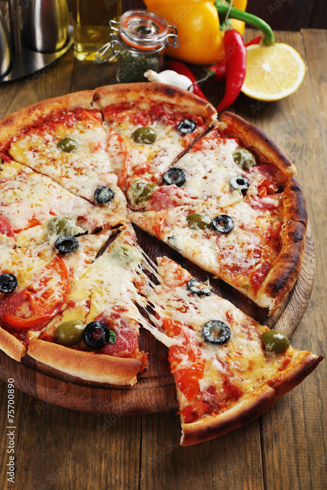 Pizza with cheese on board and wooden table background