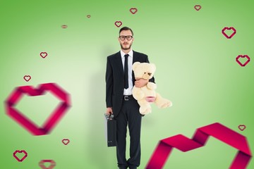 Poster - Composite image of geeky businessman holding briefcase and teddy