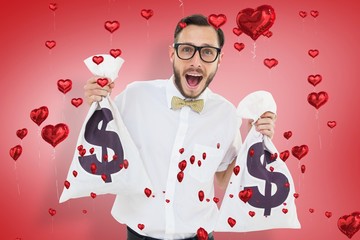 Leinwandbilder - Composite image of geeky businessman holding money bags