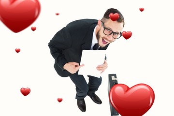 Poster - Composite image of geeky smiling businessman showing paper