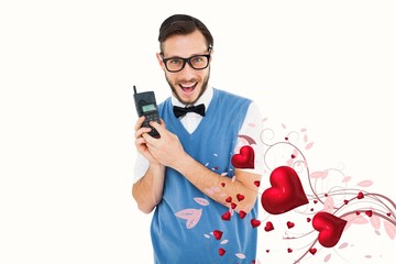Poster - Composite image of geeky hipster holding a retro cellphone