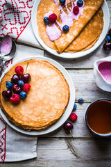 Wall Mural - Pancakes with berries on wooden background