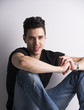 © theartofphoto - Handsome young man sitting on the floor