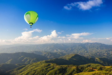 Wall Mural - Hot air balloon over mountain