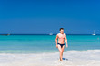 © Valeri Luzina - Young man walking out of the water in a tropical beach