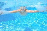 Fototapeta Łazienka - Kid swims in pool underwater, girl swimming and having fun