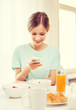 © Syda Productions - smiling young woman with smartphone reading news