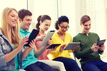 Wall Mural - smiling students with tablet pc at school