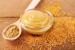 Composition of different kinds of mustard on wooden background