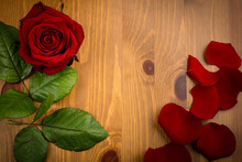 Single Rose And Pettles With Leaf On Wood