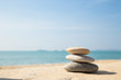 Leinwandbild Motiv Stones balance, pebbles stack on sea sand beach